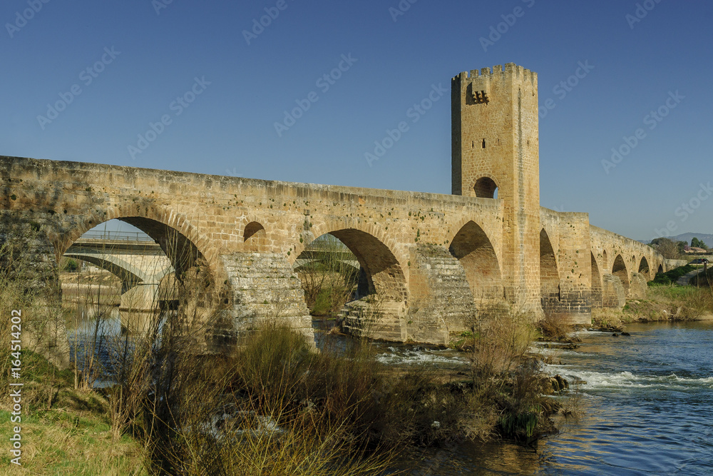 medieval bridge on the river Ebro in the city of Frias and of its castle in the north of the province of Burgos in Spain. medieval bridge on the river Ebro in the city of Frias and of its castle in the north of the province of Burgos in Spain.