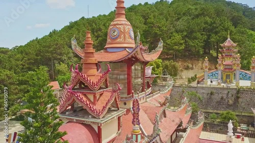 Flycam Shows Red Fretted Pagoda Roof among Buildings Plants photo