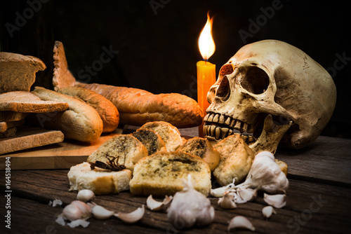 Photography Still Life Skull , Bone , Bread , Garlic , Candle Light , Cockroach on Old Wood