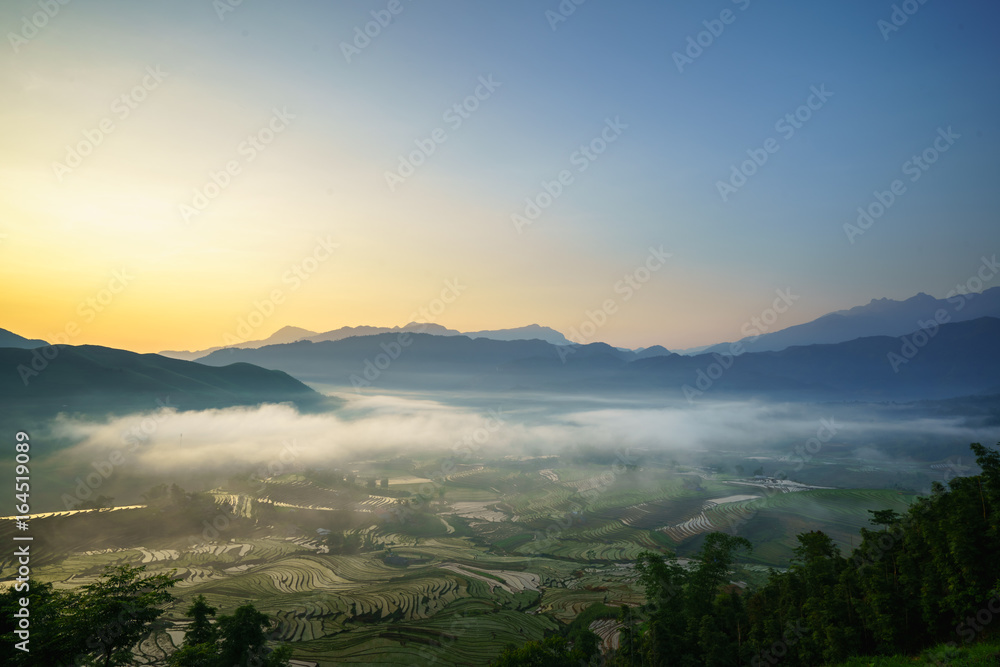 Terraced rice field in water season, the time before starting grow rice, with clouds on background in Y Ty, Lao Cai province, Vietnam