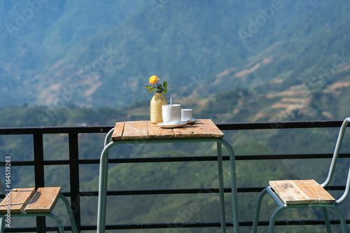 Coffee table with mountain background in the morning