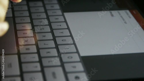 Typing an email on a touchscreen keyboard,Virtual Keyboard,Shallow depth of field. photo