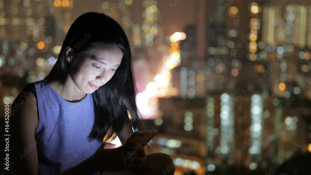 Woman sending sms on mobile phone Woman sending sms on mobile phone