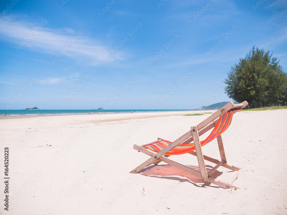 Red canvas chair on the beach.