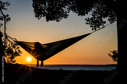A person enjoying the sunset in a hammock