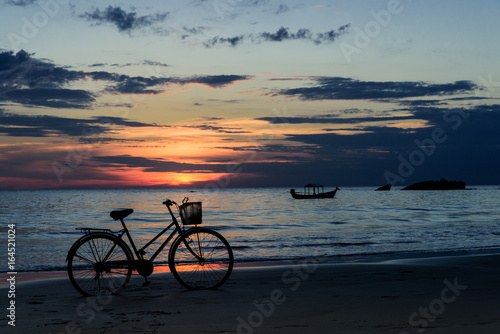 Bicycle and boat at sunset on bay of Bengal