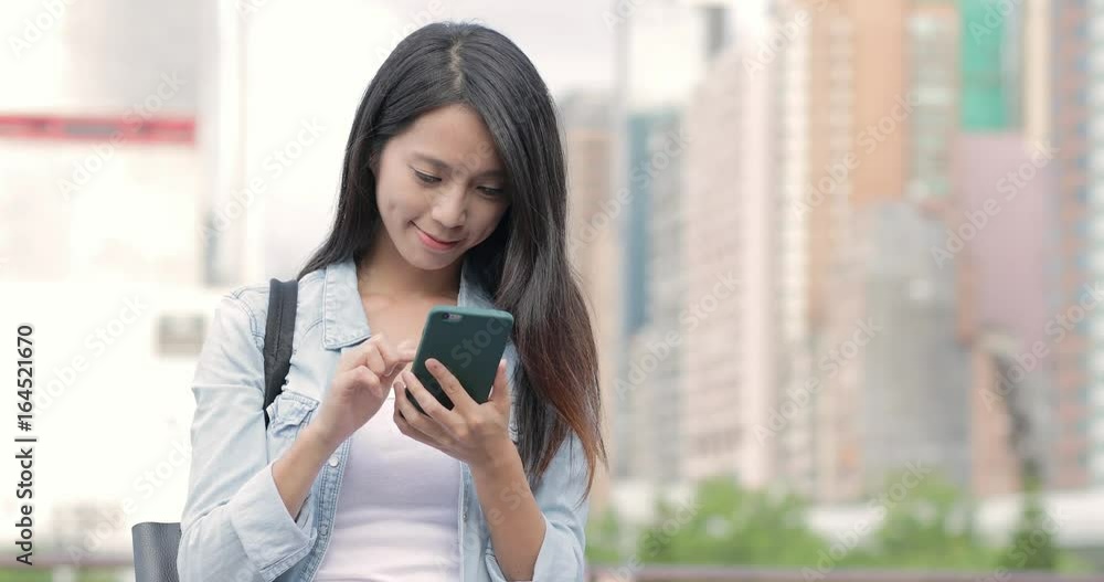 Woman use of mobile phone at outdoor