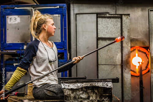 Blowing Glass Professional Woman Working on a Vase.