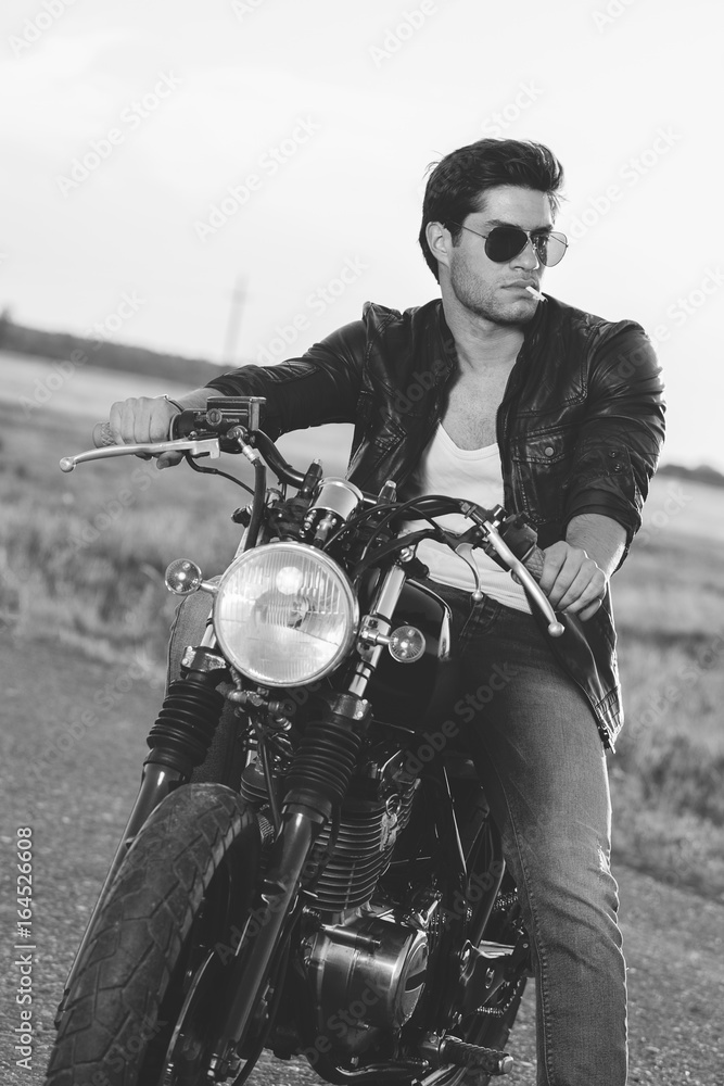 Fototapeta premium Biker man sits on a bike