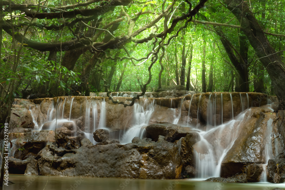 Small waterfall in the forest in summer. Small waterfall in the forest in summer.