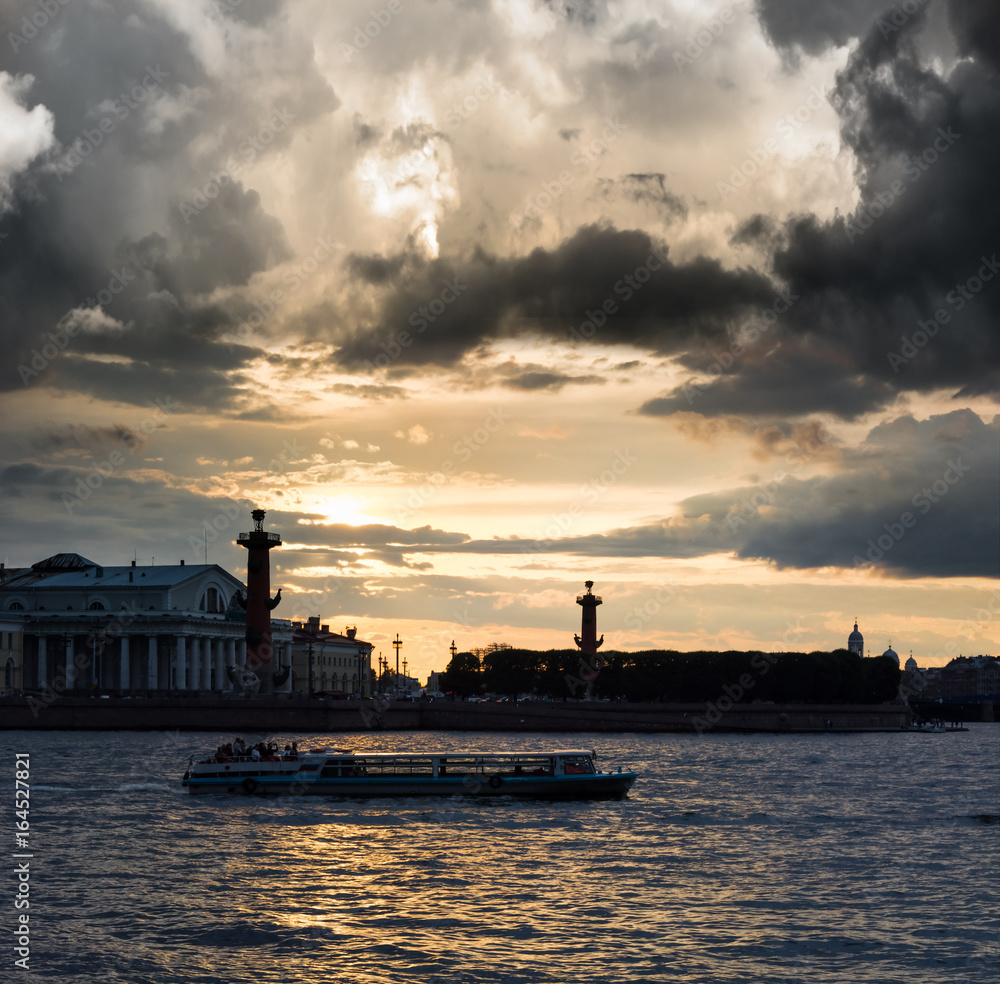 Old Saint Petersburg Stock Exchange and Rostral Columns at Neva river on sunset, Russia