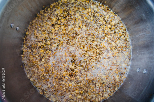 Bilde på lerret Mashing in a Stainless Kettle a Home Brew Cream Ale  with Crushed Barley and Cor