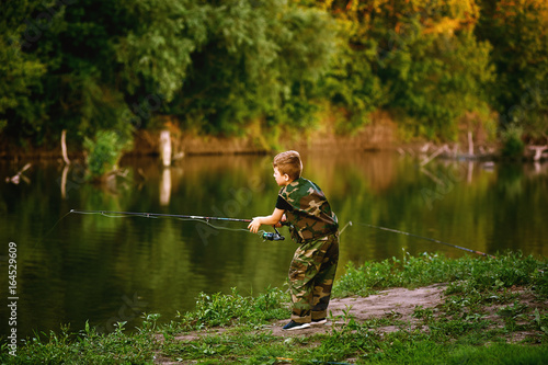 Boy catches fish in the river.The concept of tourism and leisure
