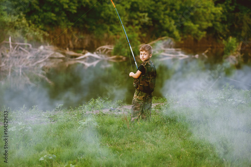 Boy catches fish in the river.The concept of tourism and leisure