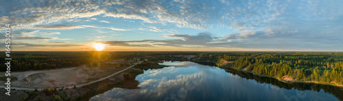Beautiful sunset over the lake in summer forest. Aerial photography. Panorama.