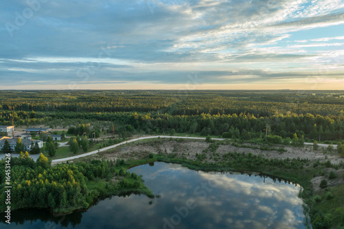 Beautiful sunset over the lake in summer forest. Aerial photography. © nikwaller