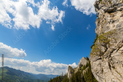 Mountain scenery in the Transylvanian Alps, on a bright summer day with blue skies and limestome cliffs photo