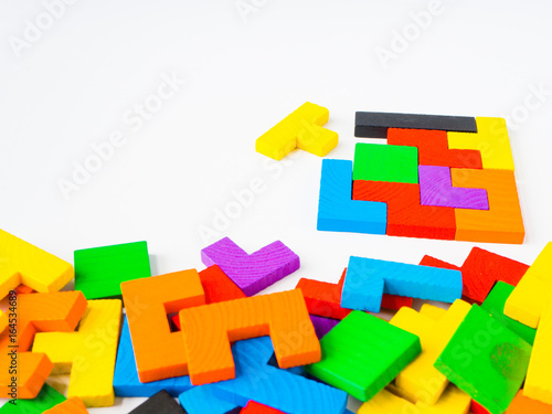 Education concept- The last piece to complete a square tangram puzzle colorful wooden, puzzle for kid on white background
