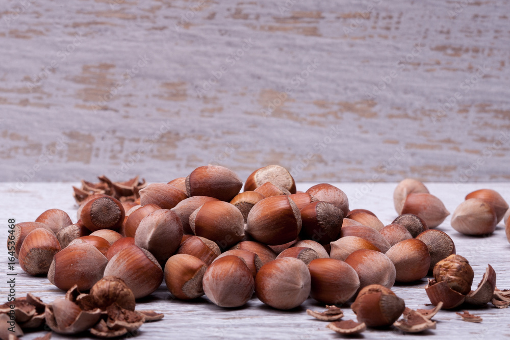 Hazelnuts on white wooden background in studio photo