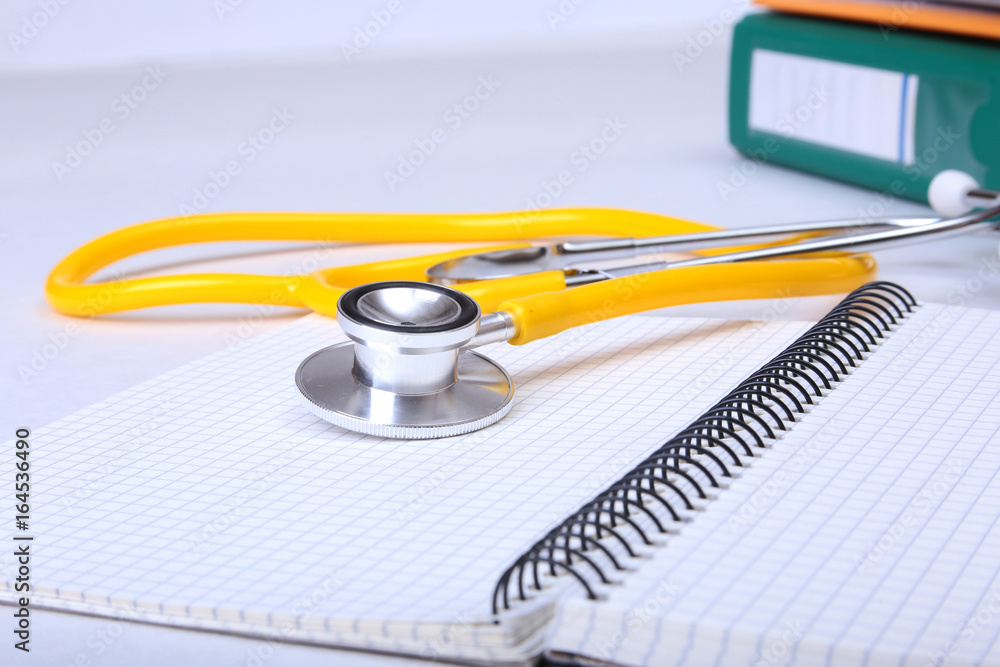 Folder file, stethoscope and RX prescription on the desk. blurred background. Folder file, stethoscope and RX prescription on the desk. blurred background.