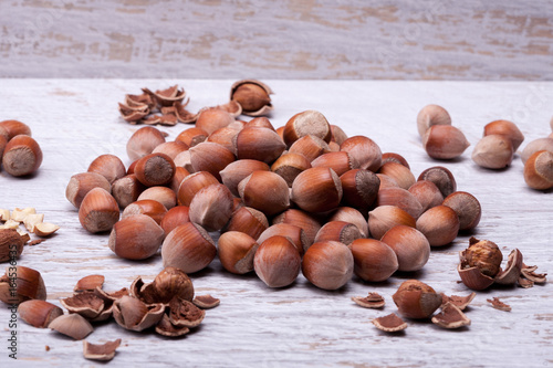Hazelnuts on white wooden background in studio photo