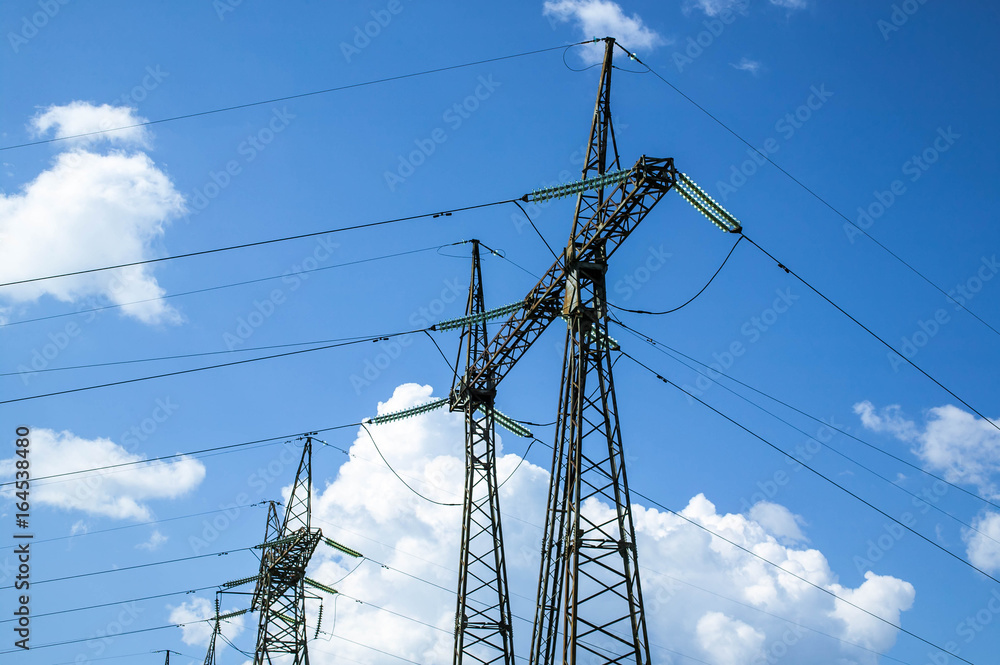 High voltage power line  on a blue sky background. Close-up