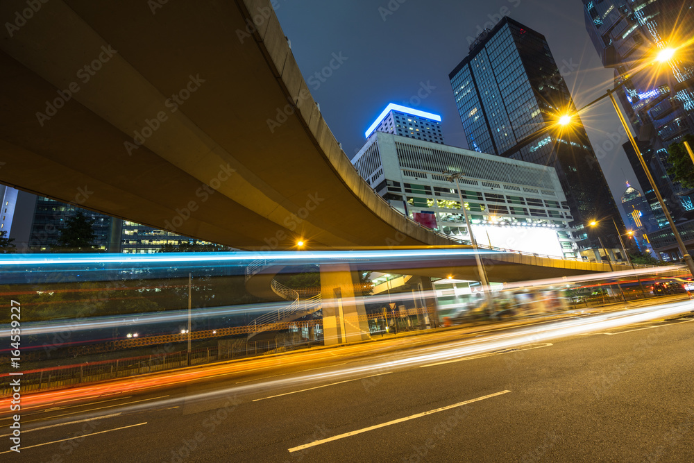 urban traffic road with cityscape in background at night in Shanghai,China.