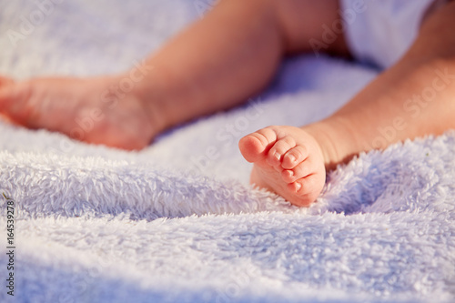 Closeup legs of little girl on soft pillow