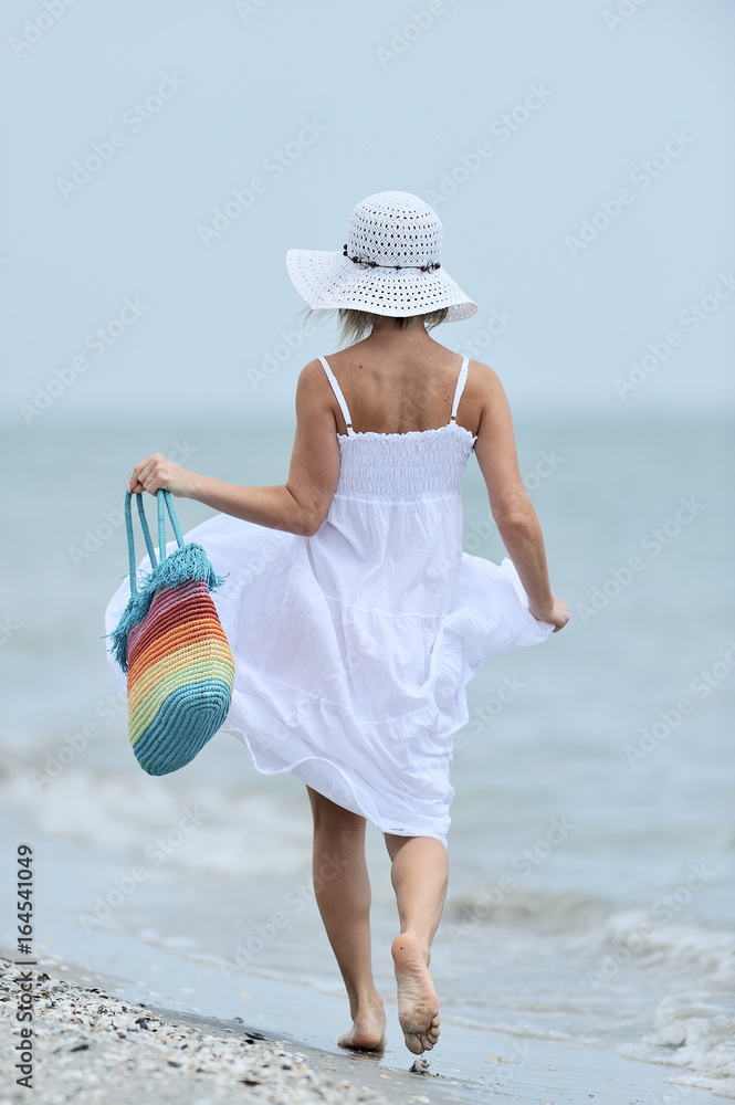 young happy woman on the beach in summer