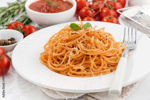 pasta with tomato sauce on a plate and ingredients