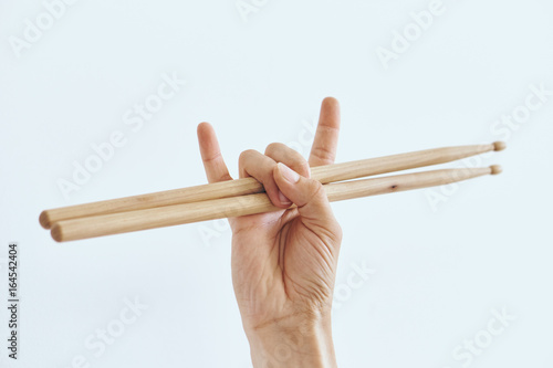Hand on white isolated background, rock, drumsticks