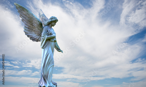Beautiful angel in heaven over cloudy sky photo