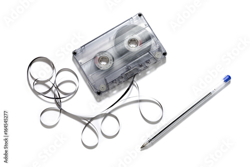 Tela Retro cassette with loose tape over a white background