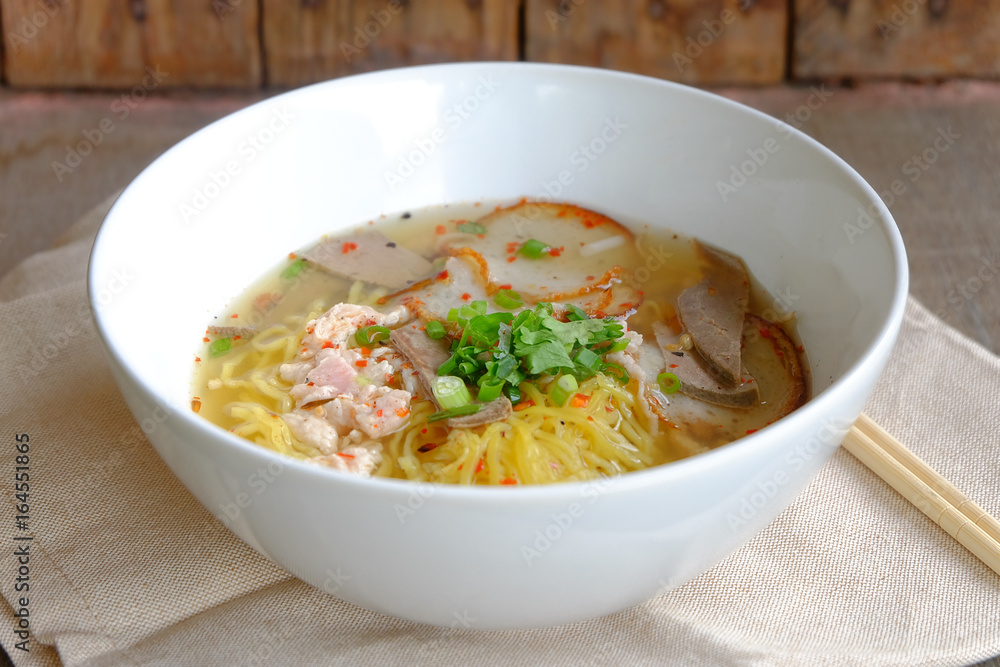 spicy pork noodles on wood floor spicy pork noodles on wood floor