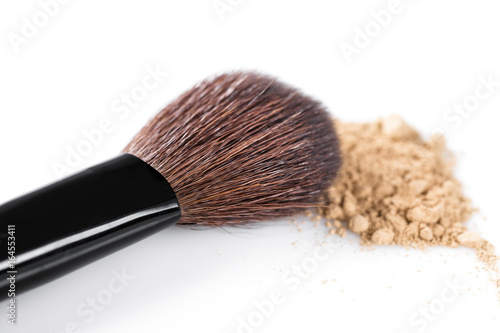 Beige powder for face and makeup brush isolated on white background
