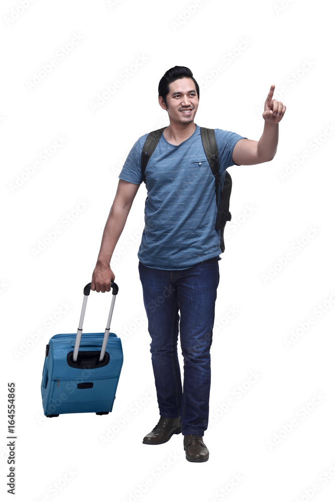 Happy asian traveler with backpack and suitcase pointing something Happy asian traveler with backpack and suitcase pointing something