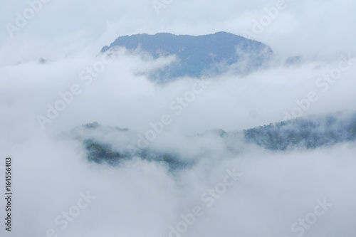 Top view of mountains covering with fog