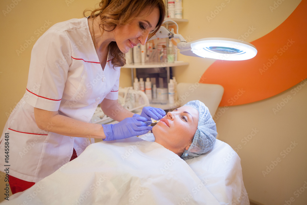doctor beautician increases lip patient an injection syringe doctor beautician increases lip patient an injection syringe