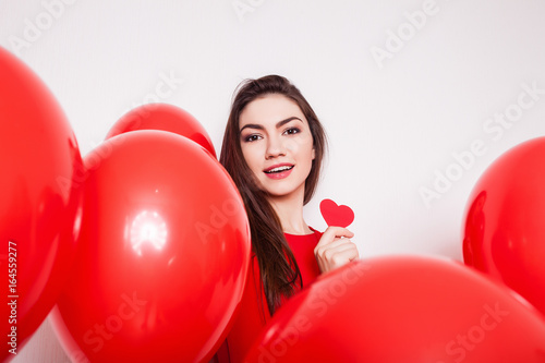 Beautiful brunette girl holds Paper red heart on a white background © aemstock