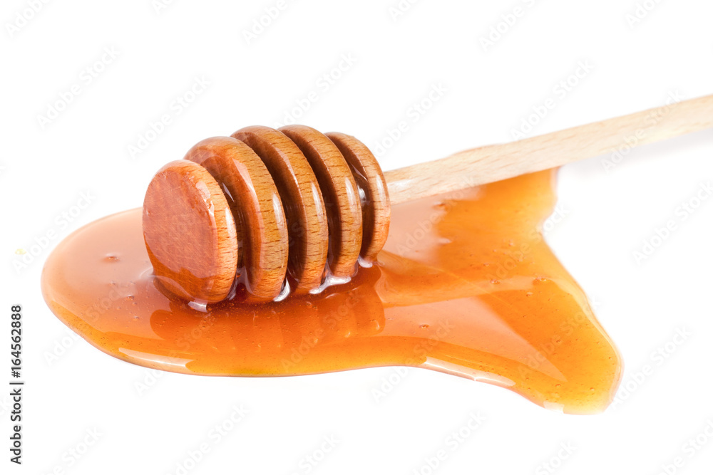 Honey stick with flowing honey isolated on white background Honey stick with flowing honey isolated on white background