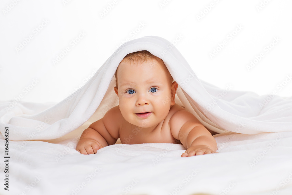 Cute smiling baby under towel after bath Cute smiling baby under towel after bath