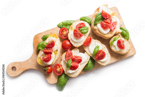 Bruschette con mozzarella, pomodoro fresco, olio di oliva, basilico e origano photo
