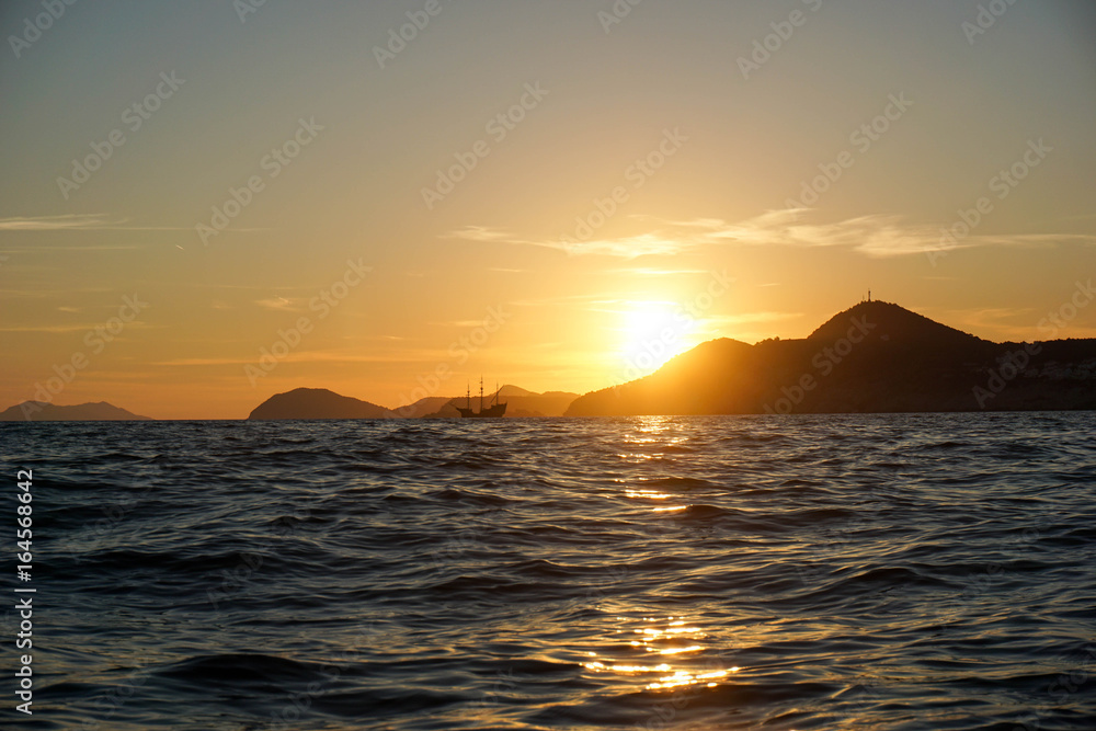 Merchant Ship Passing the Sunset in Dubrovnik Merchant Ship Passing the Sunset in Dubrovnik