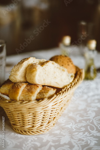 Fresh bread in basket. Slices roll breads in basket on table