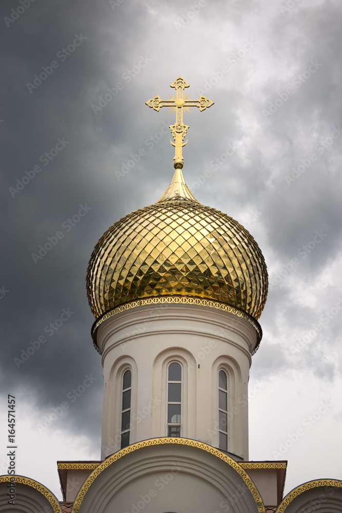 Golden dome of the church in a stormy sky. Golden dome of the church in a stormy sky.