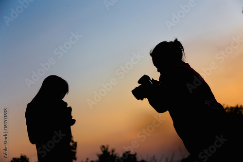 Women Nature photographer with digital camera on the mountain