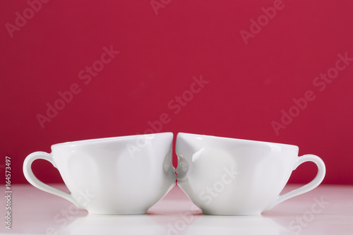 Two white cups on a red background. I love uou.
