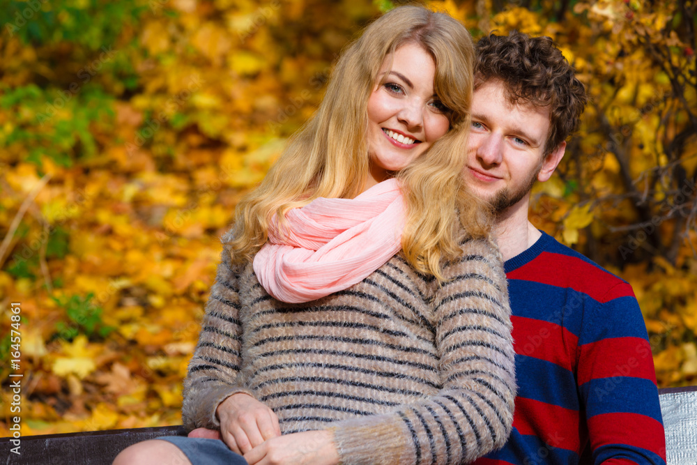 Fototapeta premium Lovers couple in autumn park on bench
