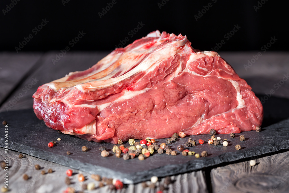Piece of fresh raw meat with pepper