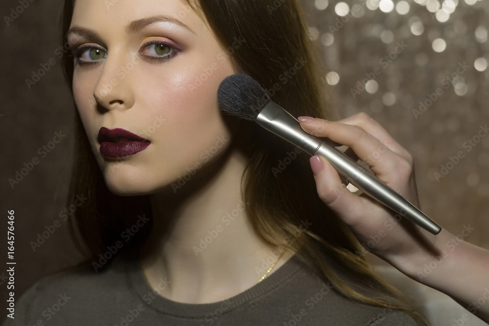 professional makeup artist working with beautiful young woman professional makeup artist working with beautiful young woman